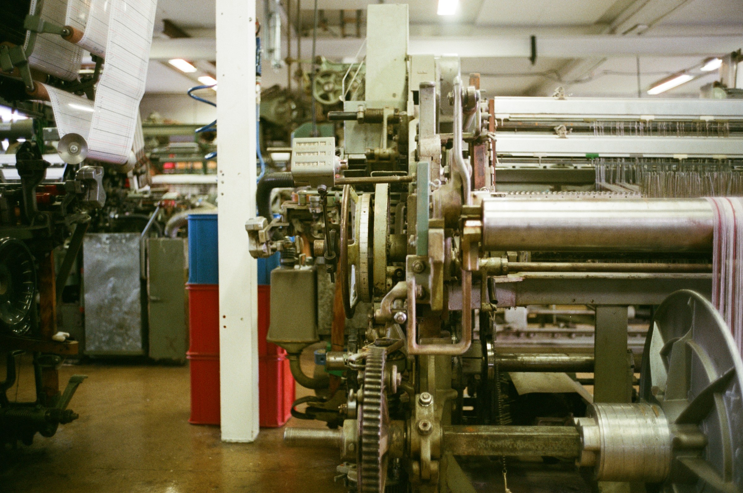 Industrial weaving loom with fabric on a roll